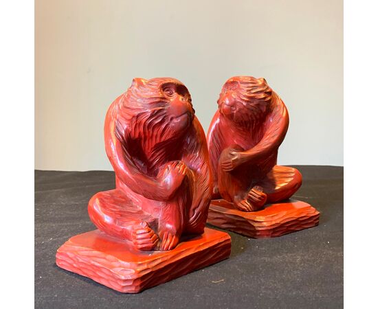Red bookends in the shape of monkeys     