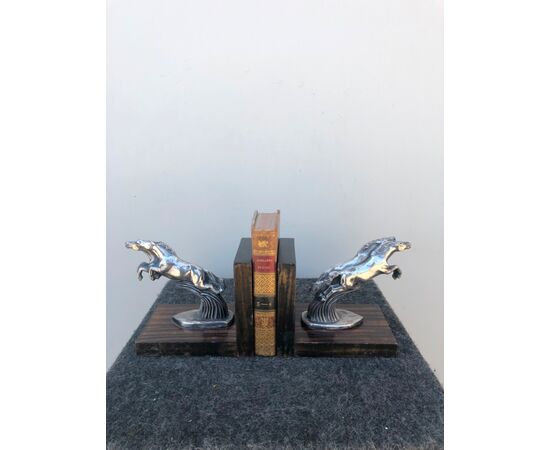 Coppia di fermalibri in metallo e legno raffiguranti cavalli stile art-d’eco’.