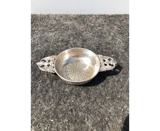 Silver colander with two perforated handles with stylized plant motifs. Silversmith Martini from Rome.     