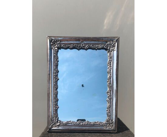 Silvered copper mirror frame with rocaille silver decoration.     