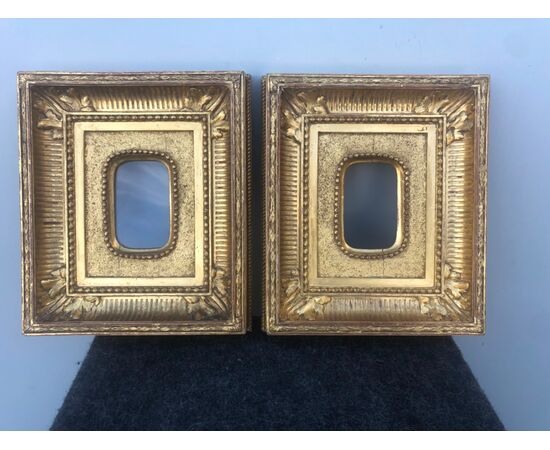 Pair of carved and gilded wooden frames with geometric and leaf motifs.     