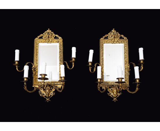 Pair of antique "Ventoline" mirrors, Napoleon III style, in gilded and chiseled bronze. France, 19th century.