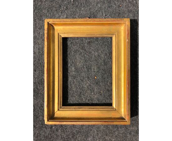 Frame in carved and gilded wood.     