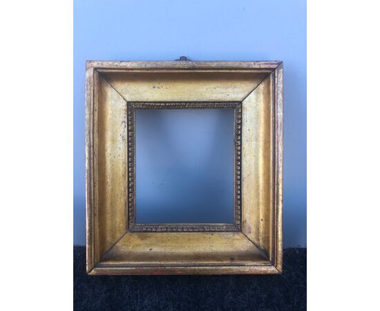 Small frame in carved and gilded wood.     