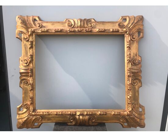Carved and gilded wooden frame with art nouveau rocaille motifs.     