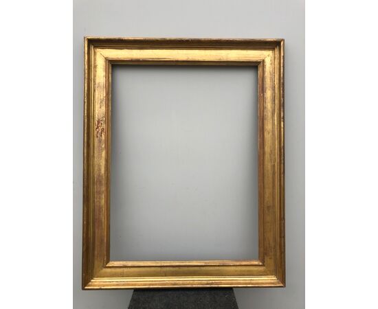 Large frame in carved and gilded wood.     