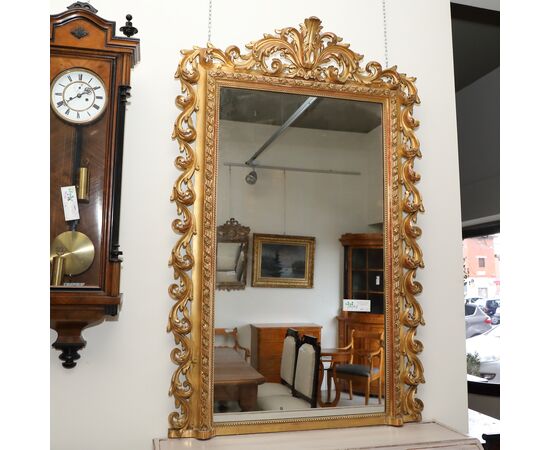 Rectangular mirror in gilded wood with carved frame     