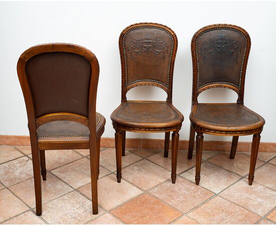 Gruppo di sei sedie antiche in massello di noce con seduta e schienale in cuoio martellato. Francia XIX secolo.