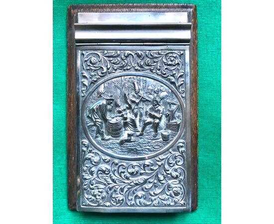 Notepad holder in rosewood and embossed silver with village scene and plant motifs. Holland.     