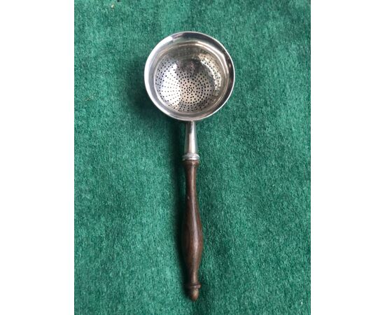 Tea strainer in silver with rosewood handle.     
