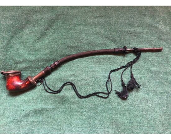 Sea foam and metal pipe with horn mouthpiece and flexible braid.     