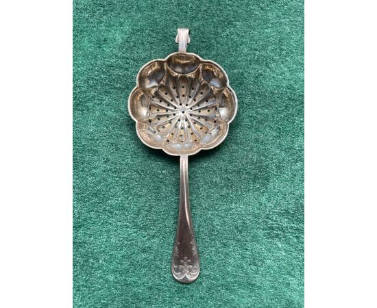 Tea stand in silver with pods and stylized plant motifs.     