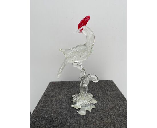 Bird in transparent glass with bubbles and variegations with red details.Murano     