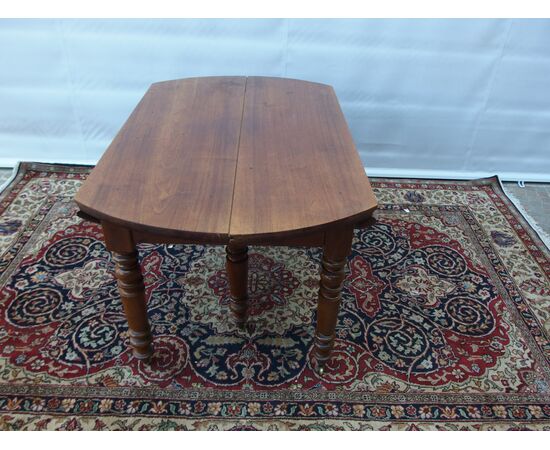 ROUND EXTENDABLE TABLE IN WALNUT, 19th CENTURY. L129xW131xH74 cm. Total extension 370 cm