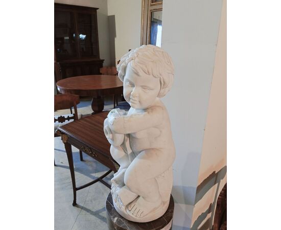 Gray marble column with white marble cherub statue