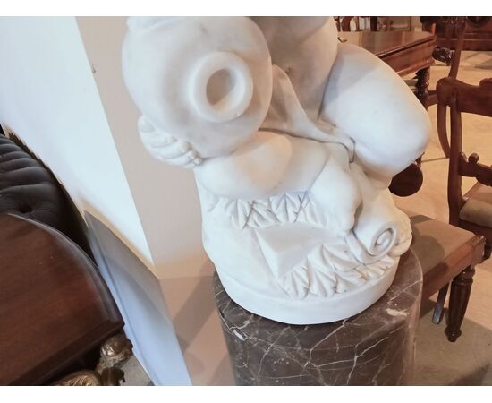 Gray marble column with white marble cherub statue