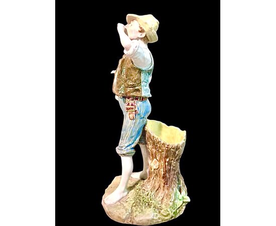 Polychrome majolica sculpture depicting a peasant drinking eggs. Ginori.