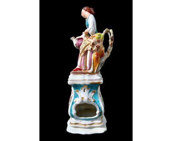 Figurative porcelain veilleuse with lady and floral decoration. France