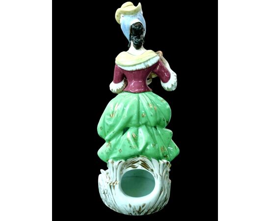 Polychrome porcelain veilleuse-teapoy depicting a lady with watering can. France