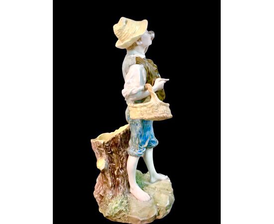 Polychrome majolica sculpture depicting a peasant drinking eggs. Ginori.