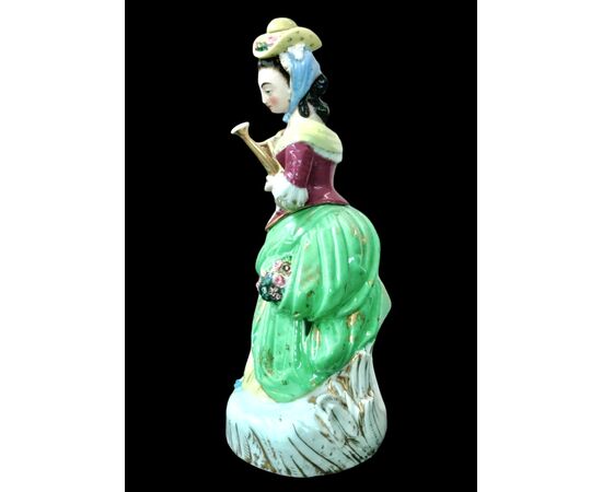 Polychrome porcelain veilleuse-teapoy depicting a lady with watering can. France