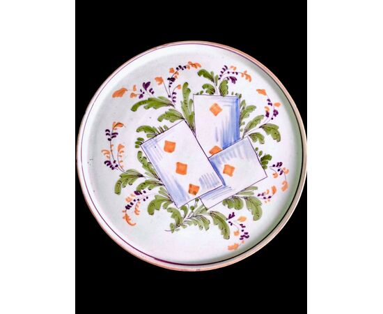 Majolica serving plate/cutting board with plant motifs and playing card decoration. Pavia.