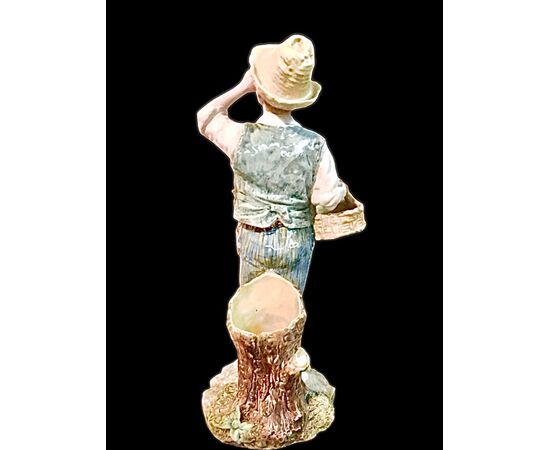 Polychrome majolica sculpture depicting a peasant drinking eggs. Ginori.