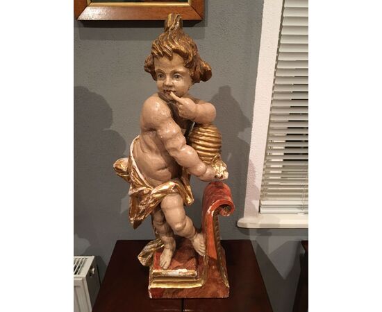 Scultura in legnio "Putto degustando miele"