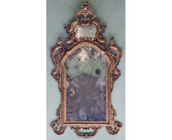 Carved, sculpted, and gilded wooden mirror. Venice, mid-18th century.