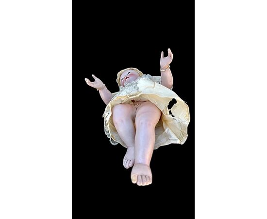 Polychrome wooden sculpture depicting the baby Jesus.