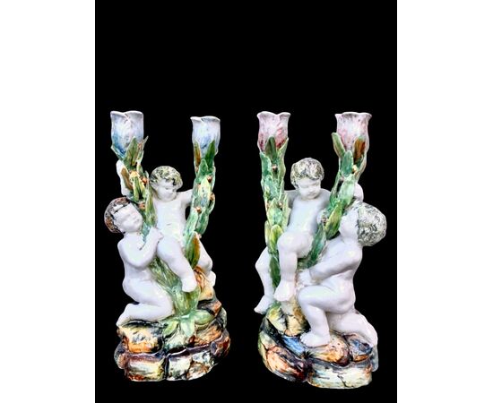Pair of two-light majolica candlesticks with putti. Minghetti manufacture. Bologna.