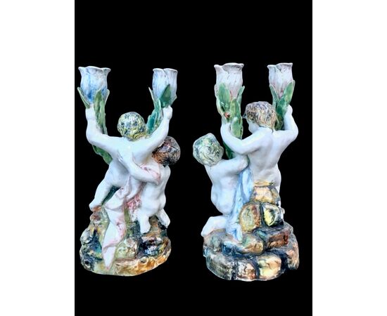 Pair of two-light majolica candlesticks with putti. Minghetti manufacture. Bologna.