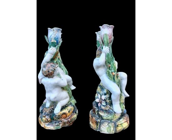 Pair of two-light majolica candlesticks with putti. Minghetti manufacture. Bologna.