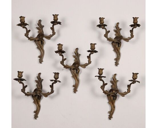 Group of five two-light bronze sconces. 19th century