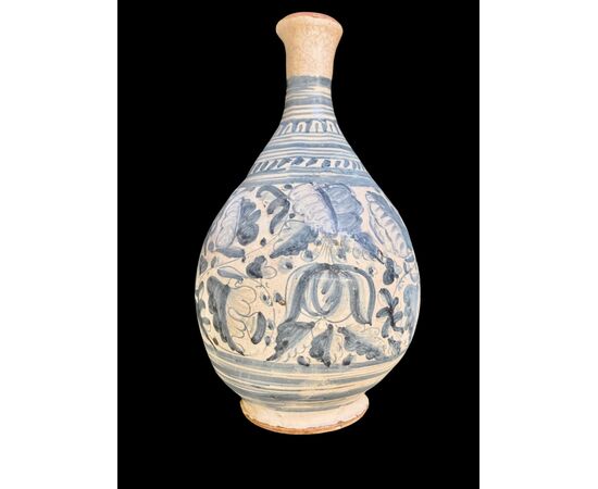 Majolica bottle with turquoise monochrome decoration depicting stylized plant motifs. Montelupo.