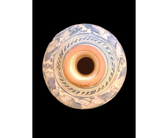 Majolica bottle with turquoise monochrome decoration depicting stylized plant motifs. Montelupo.
