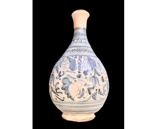 Majolica bottle with turquoise monochrome decoration depicting stylized plant motifs. Montelupo.