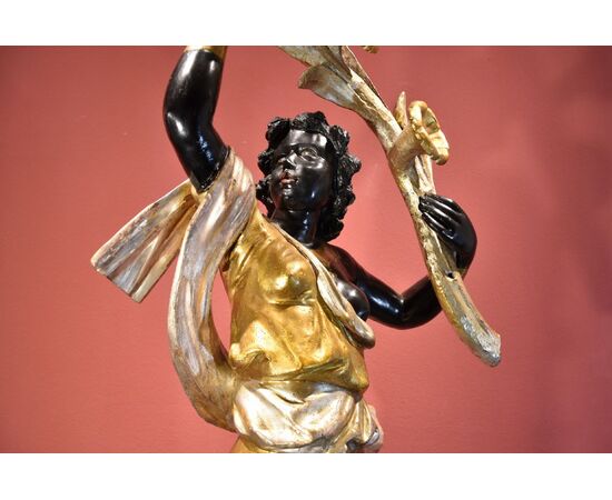 Antique sculpture of a female Moor with a flowered cornucopia