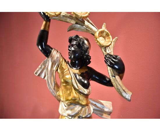 Antique sculpture of a female Moor with a flowered cornucopia
