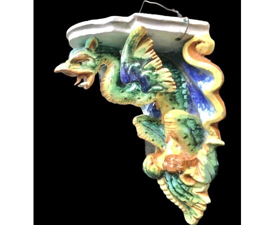 Majolica shelf with support in the shape of a winged dragon. Imola manufacture.