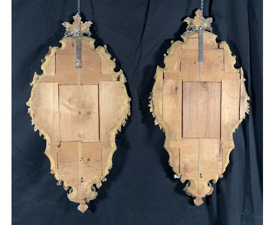 Pair of carved and gilded wooden mirrors. Italy, 18th century.