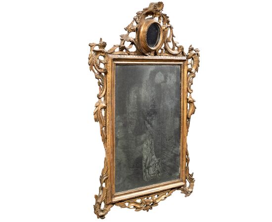 Carved and gilded wooden mirror. Venice, 18th century.
