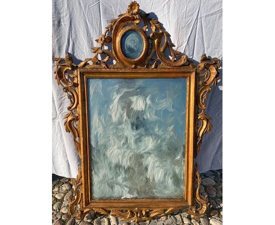 Carved and gilded wooden mirror. Venice, 18th century.