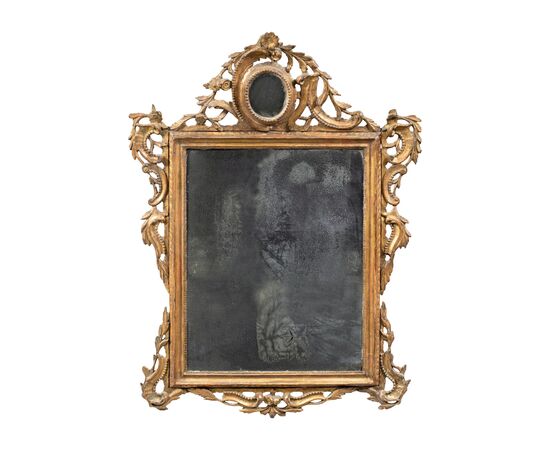 Carved and gilded wooden mirror. Venice, 18th century.