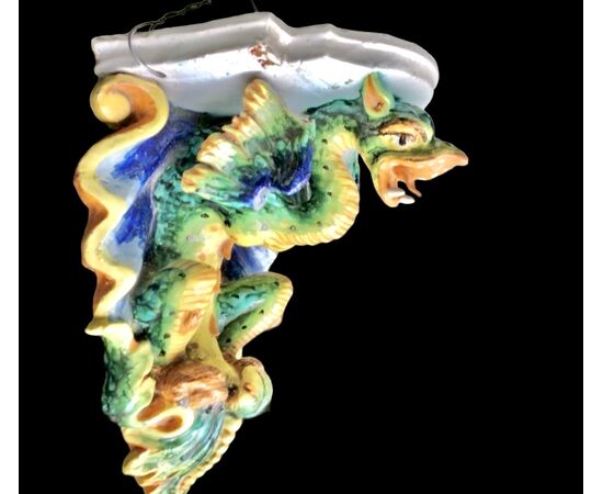 Majolica shelf with support in the shape of a winged dragon. Imola manufacture.