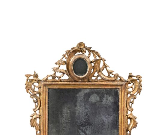 Carved and gilded wooden mirror. Venice, 18th century.