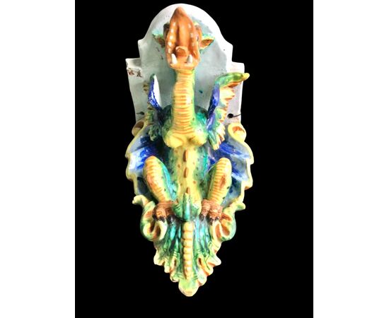 Majolica shelf with support in the shape of a winged dragon. Imola manufacture.