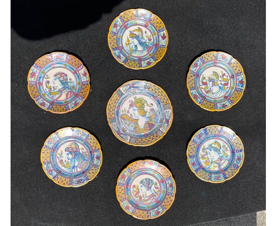 Seven majolica plates decorated in third fire luster with warrior profiles and stylized plant motifs.Gualdo Tadino.     