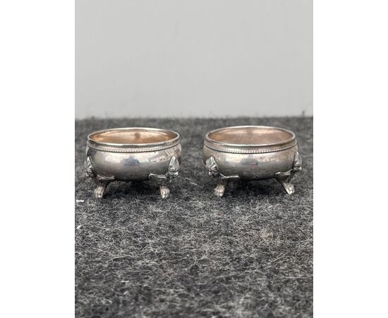 Pair of three-footed silver salt cellars with figures of harpies.     