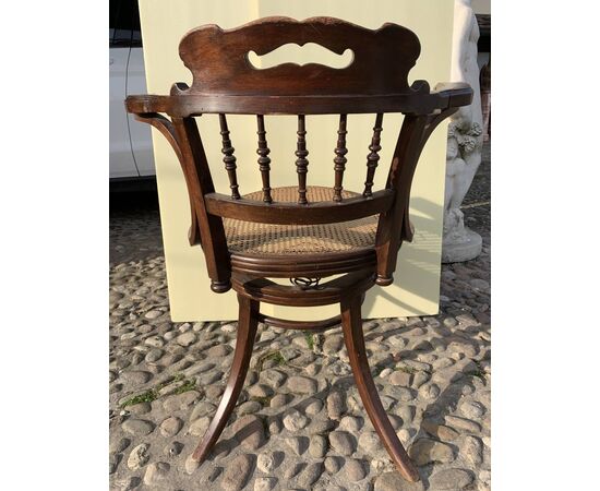 Poltroncina da ufficio in legno intagliato. Probabile manifattura Thonet - Vienna, inizi XX secolo.